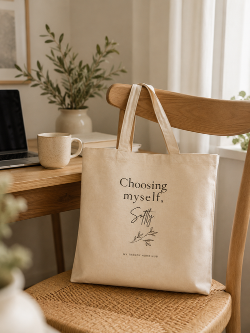 Choosing Myself, Softly canvas tote bag hanging on a wooden chair beside a cozy home office desk with a laptop, coffee mug, and natural morning light.